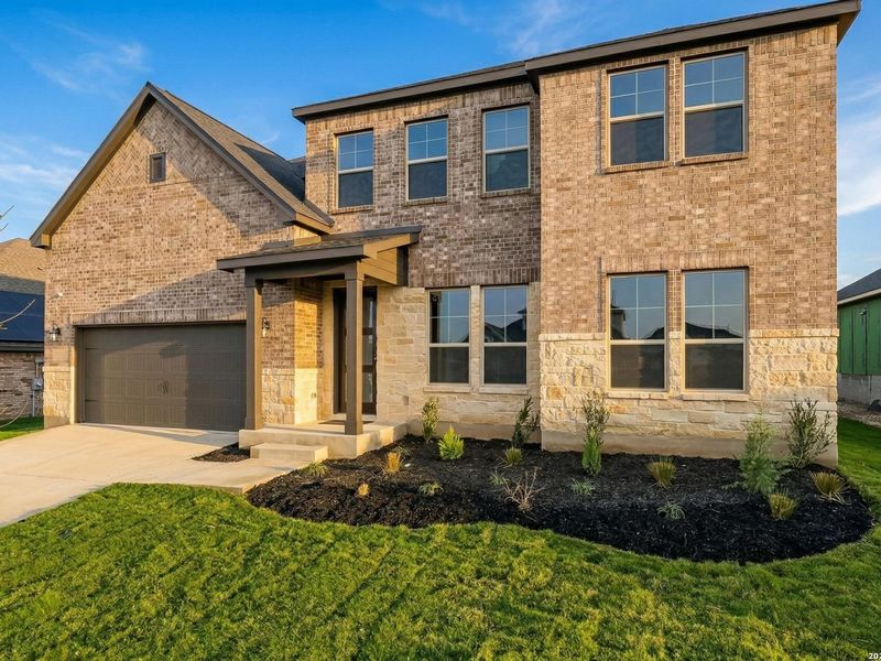 Front exterior of a new home in The Reserve at Potranco Oaks, Castroville, TX, highlighting curb appeal (Image 29).