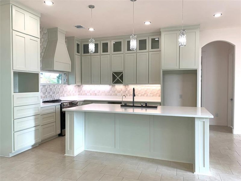 Kitchen featuring electric range, premium range hood, decorative light fixtures, backsplash, and recessed lighting Kitchen featuring electric range, premium range hood, decorative light fixtures, backsplash, and recessed lighting