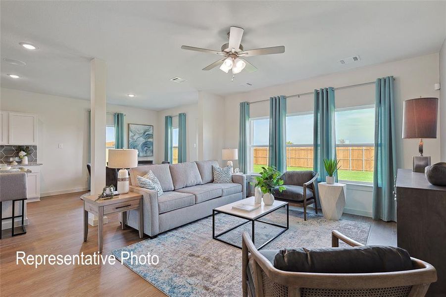 Spacious living area featuring wood-finish flooring, recessed lighting, and a ceiling fan