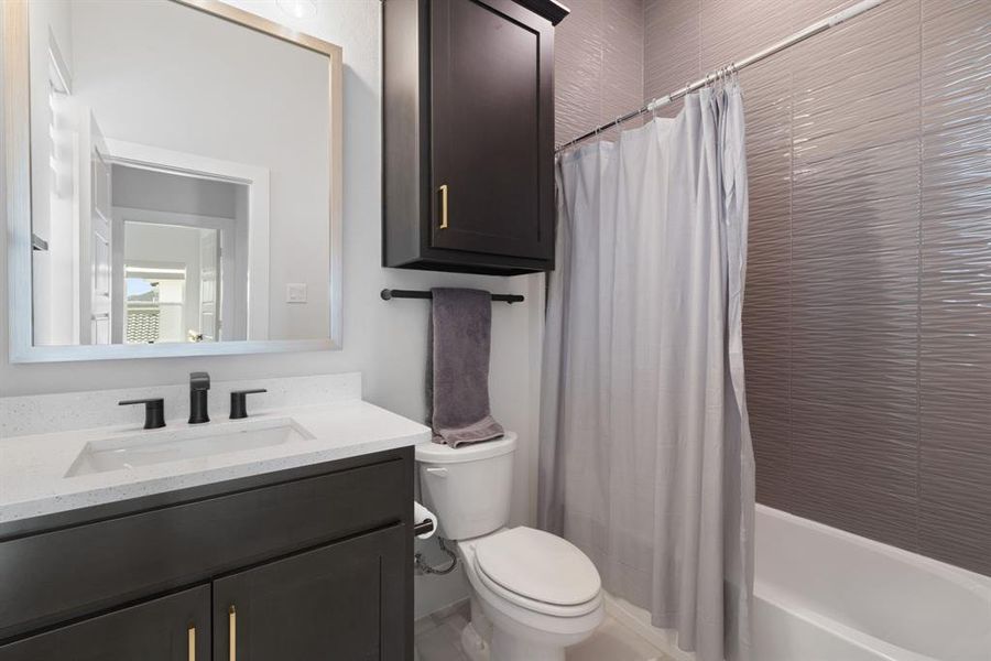 Full bathroom featuring vanity and shower / bath combination with curtain