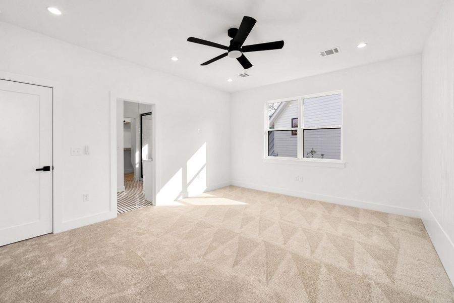 Unfurnished bedroom featuring ceiling fan, light colored carpet, and recessed lighting