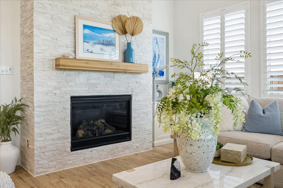 Living room featuring upgraded Gas-log fireplace.