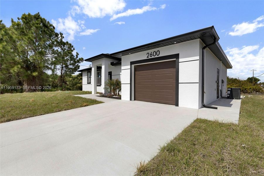 Front exterior of a new home in , Lehigh Acres, FL, highlighting curb appeal (Image 28).