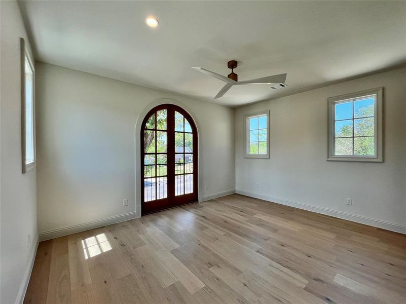 Entryway with light wood-type flooring, ceiling fan, and french doors