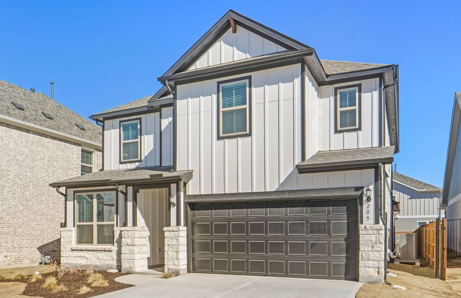 Front exterior of a new home in Santa Rita Ranch, Liberty Hill, TX, highlighting curb appeal (Image 21).