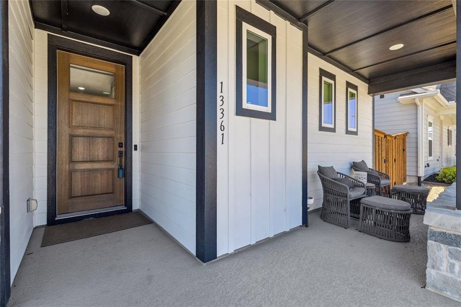View of exterior entry featuring a porch and board and batten siding View of exterior entry featuring a porch and board and batten siding