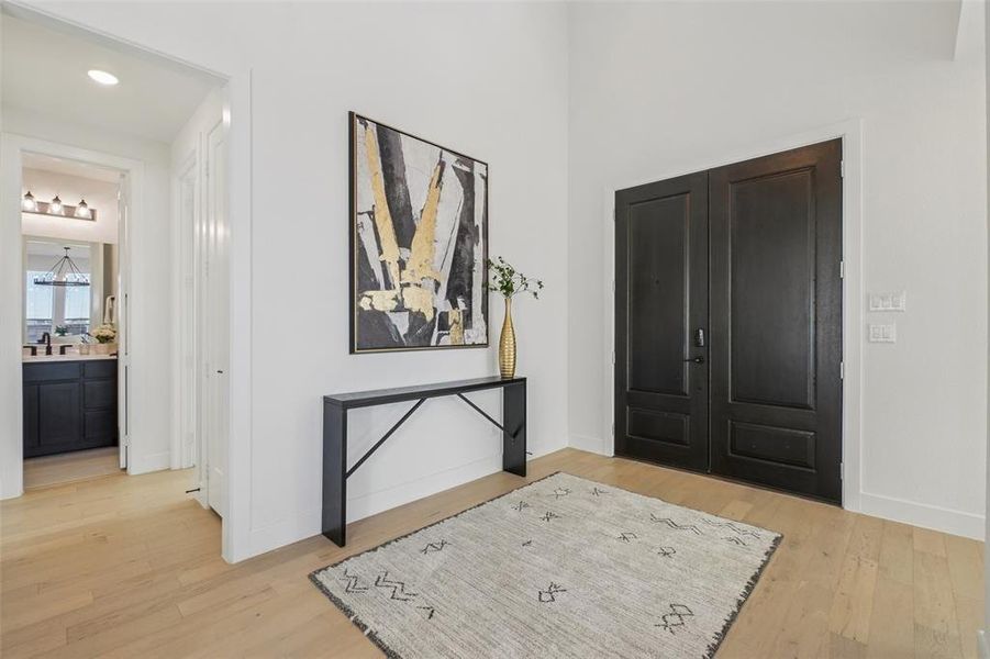 Foyer with light wood-type flooring and baseboards Foyer with light wood-type flooring and baseboards