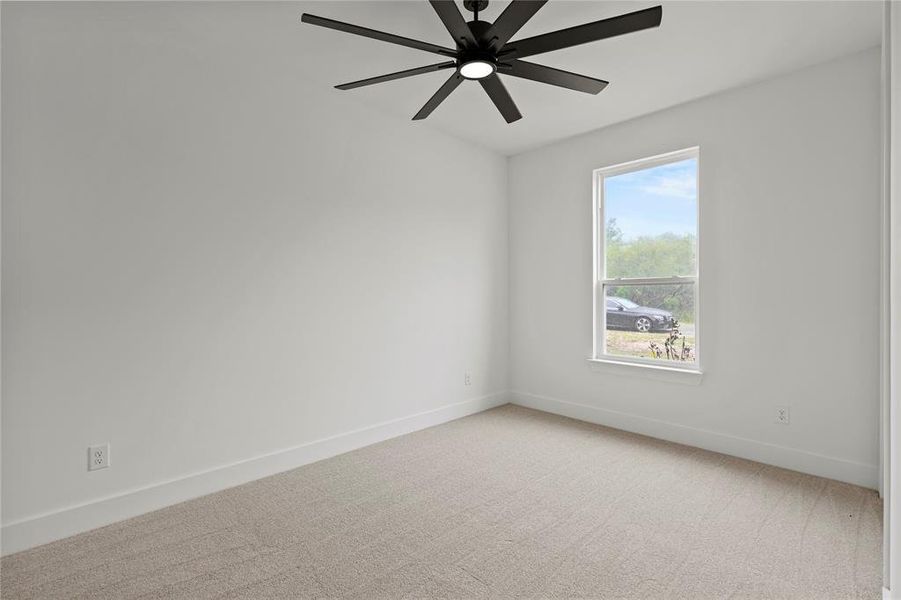 Spare room with light colored carpet and ceiling fan Spare room with light colored carpet and ceiling fan