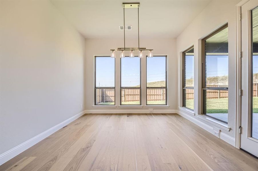 Unfurnished dining area with light wood-type flooring