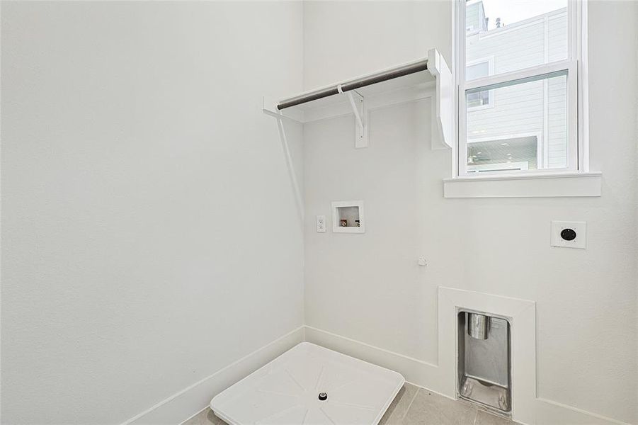 Washroom featuring hookup for an electric dryer, hookup for a washing machine, gas dryer hookup, and plenty of natural light