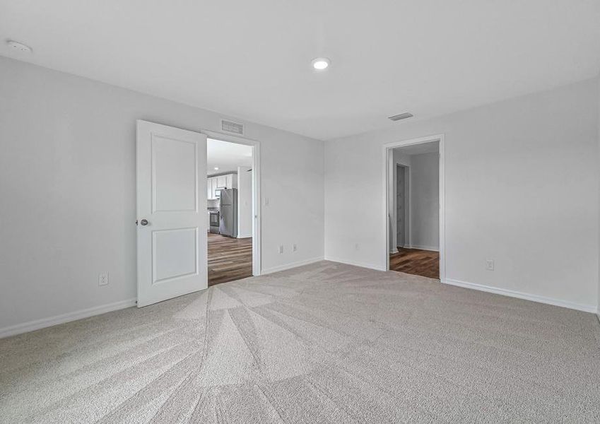 The beautiful master bedroom has plenty of room with an attached bathroom The beautiful master bedroom has plenty of room with an attached bathroom