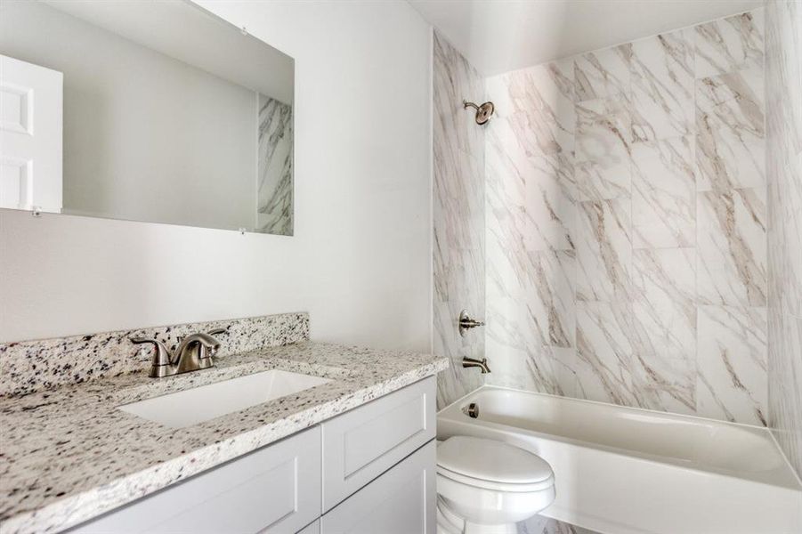 Bathroom featuring shower / washtub combination and vanity