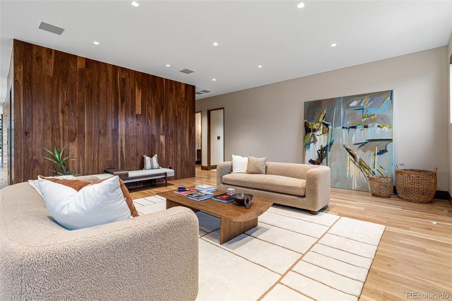 The family room also has artisan crafted trowel finish walls plus a beautiful walnut accent wall. Inset walnut baseboards and wide plank white oak flooring.