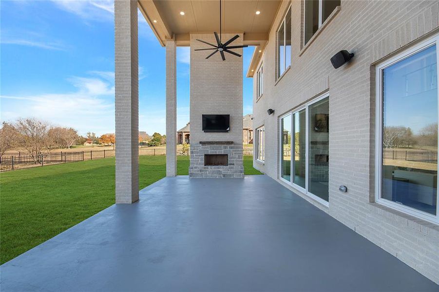 View of patio / terrace with a large fireplace and ceiling fan View of patio / terrace with a large fireplace and ceiling fan