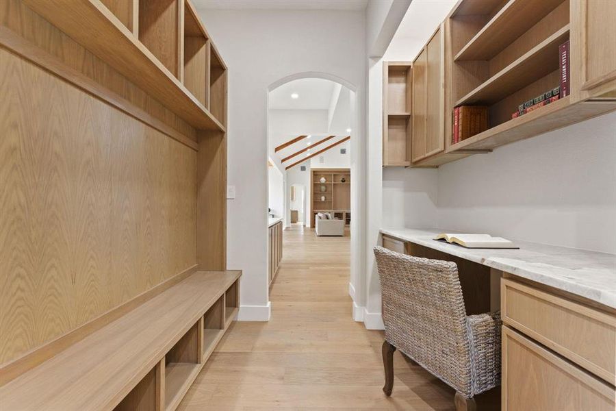 Office space featuring light wood-type flooring,
built in desk, recessed lighting, and arched
walkways Office space featuring light wood-type flooring,
built in desk, recessed lighting, and arched
walkways
