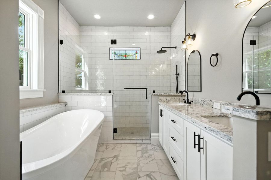 Primary bathroom - slipper tub for long soaks and lots of bubbles! Large shower with frameless glass door and bench seat Primary bathroom - slipper tub for long soaks and lots of bubbles! Large shower with frameless glass door and bench seat