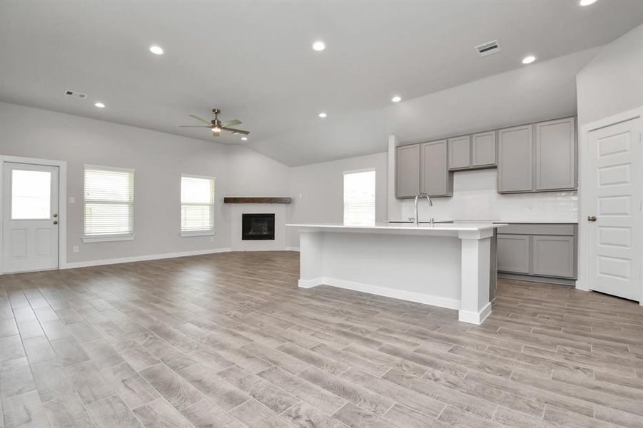 Another view of the kitchen and massive island. Sample photo of completed plan. As built color and selections may vary.