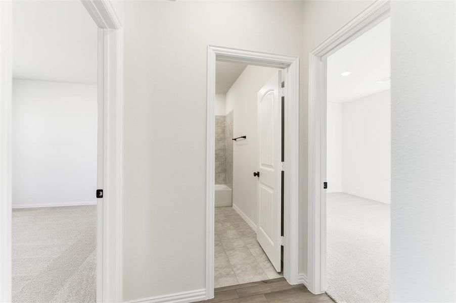 Hall featuring light colored carpet