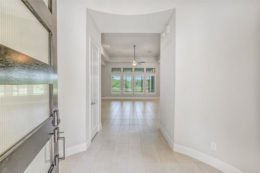 Open the 8 foot Ebony stained front door with 5 windows and you are greeted by a tiled entry hall with high ceilings. Open the 8 foot Ebony stained front door with 5 windows and you are greeted by a tiled entry hall with high ceilings.