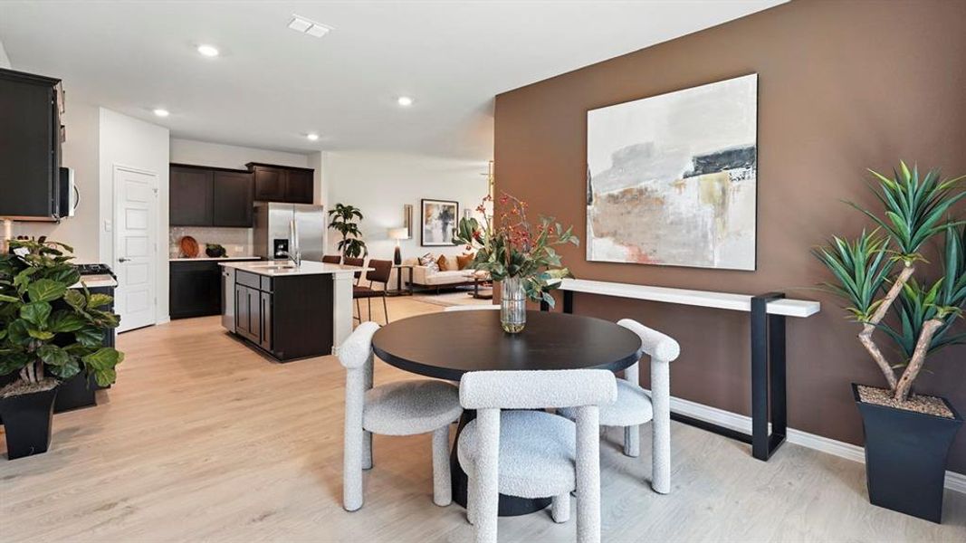 Dining room featuring light wood-style floors and recessed lighting
