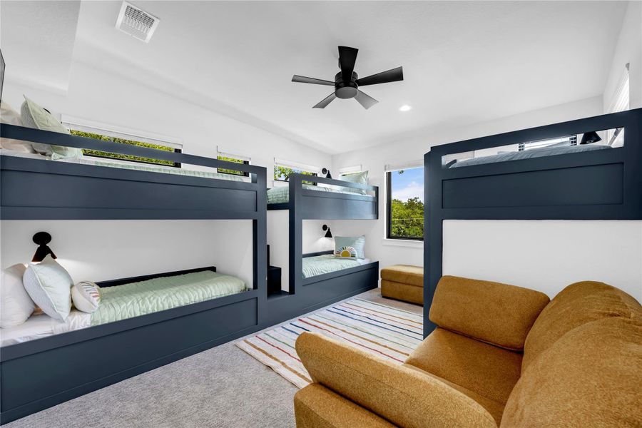 Bedroom six: Built-in bunk beds with integrated storage, contemporary ceiling fan, recessed lighting, and multiple windows