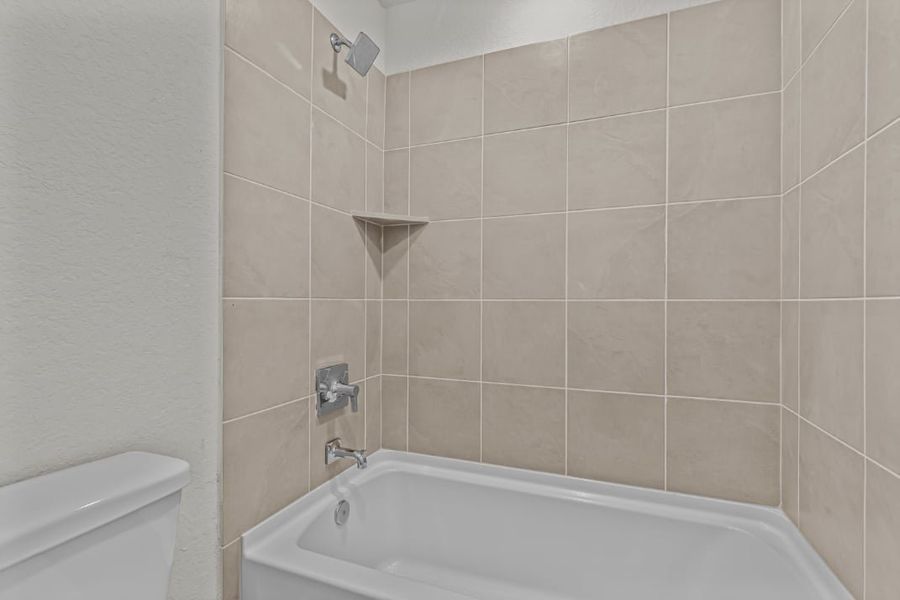 A bathtub in a bathroom.