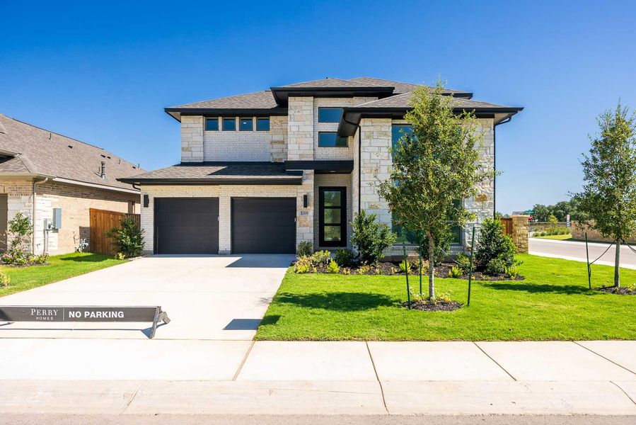 Prairie-style home with stone siding, driveway, a garage, and a shingled roof