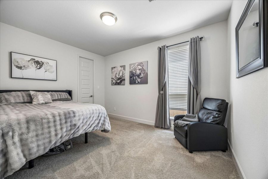 Convenient first-floor secondary bedroom with plush carpet and en-suite bath