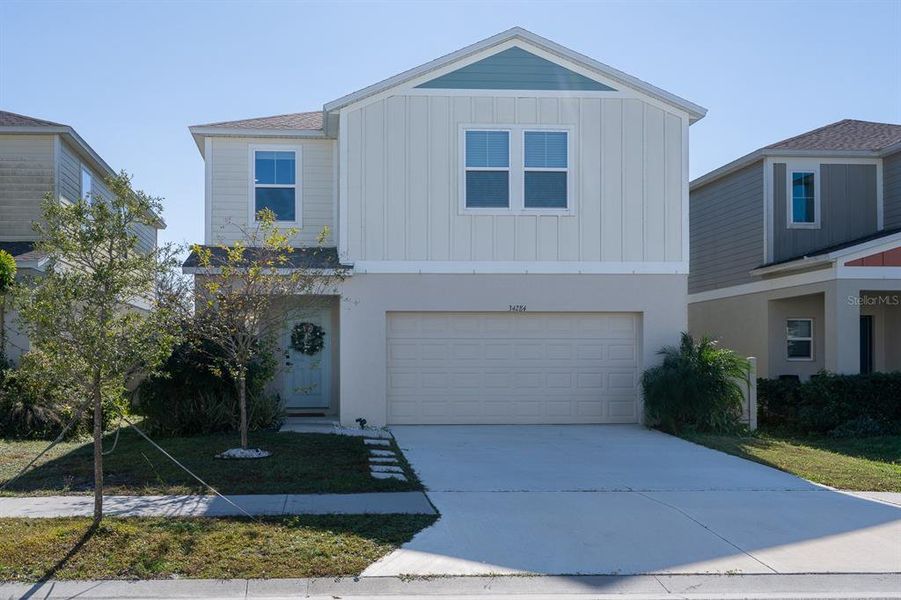 Front exterior of a new home in Pasadena Point, Wesley Chapel, FL, highlighting curb appeal (Image 29). Front exterior of a new home in Pasadena Point, Wesley Chapel, FL, highlighting curb appeal (Image 29).