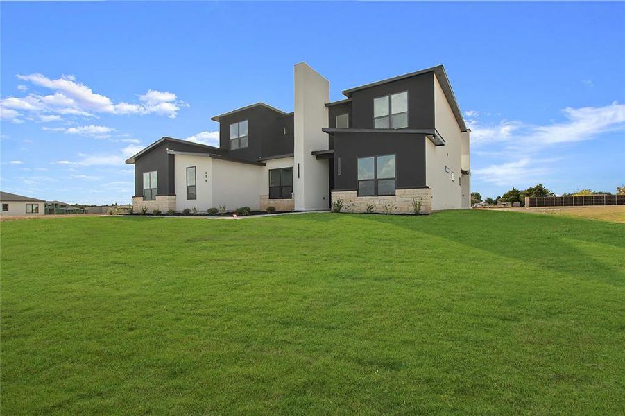 Rear view of property featuring a yard