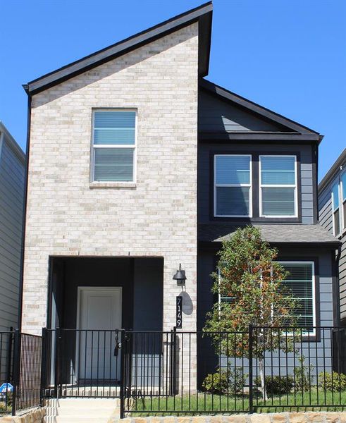 Front elevation with brick and stone veneer. Front elevation with brick and stone veneer.