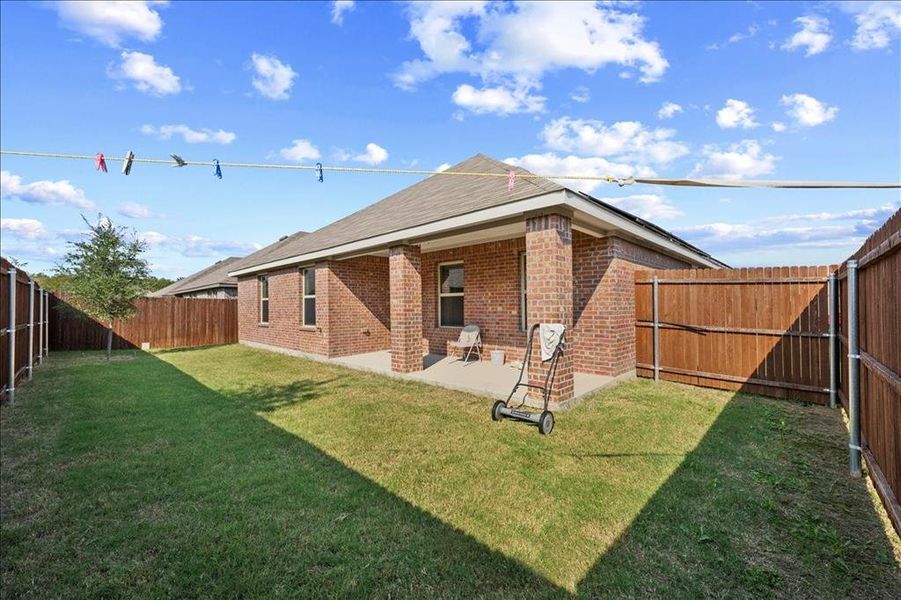Back of house featuring a patio, brick siding, and a fenced backyard Back of house featuring a patio, brick siding, and a fenced backyard