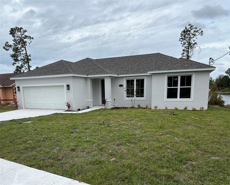 Front exterior of a new home in , Deltona, FL, highlighting curb appeal (Image 15).