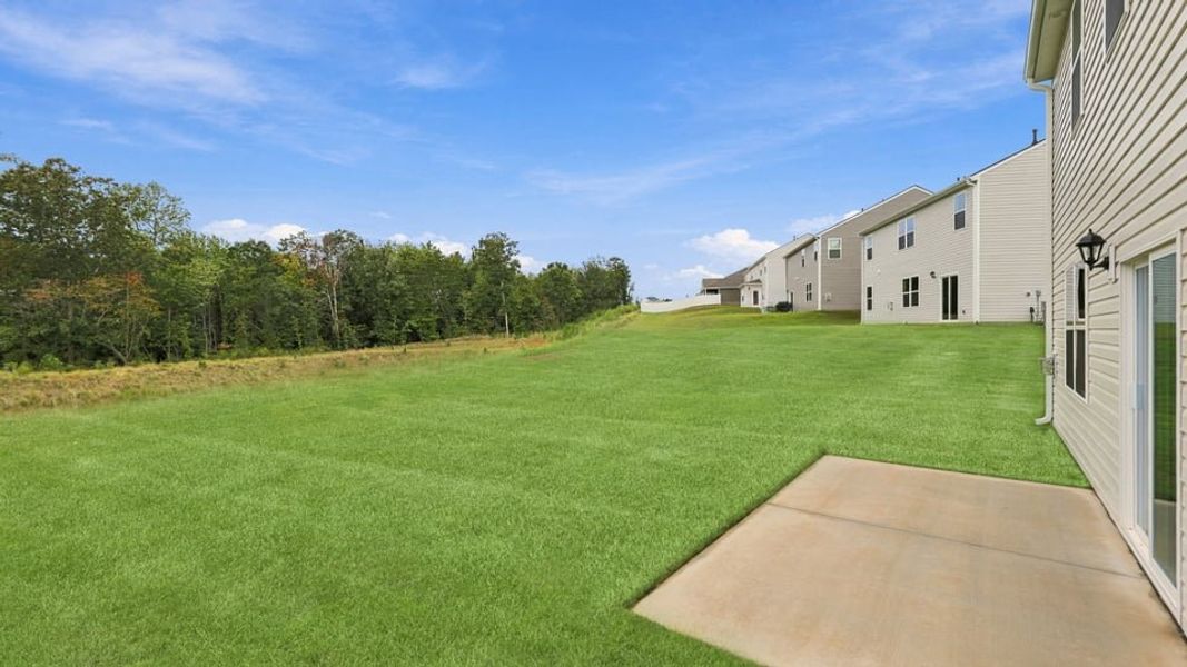 Exterior details and patio area of a home in Durbin Meadows Traditions, Fountain Inn (Image 23).