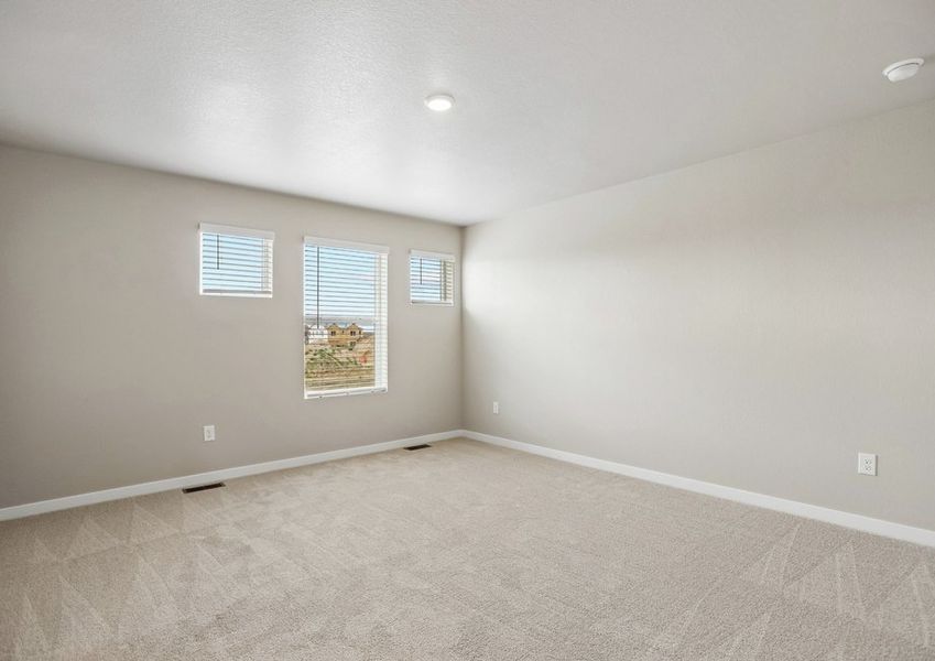 The master bedroom is spacious with large windows.