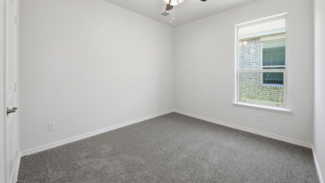 Unfurnished room with carpet flooring and ceiling fan Unfurnished room with carpet flooring and ceiling fan