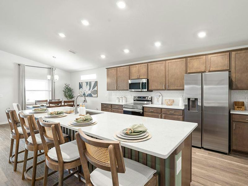 Your bright, open kitchen includes a large island and a sunny dining cafe - Serendipity by Highland Homes Your bright, open kitchen includes a large island and a sunny dining cafe - Serendipity by Highland Homes