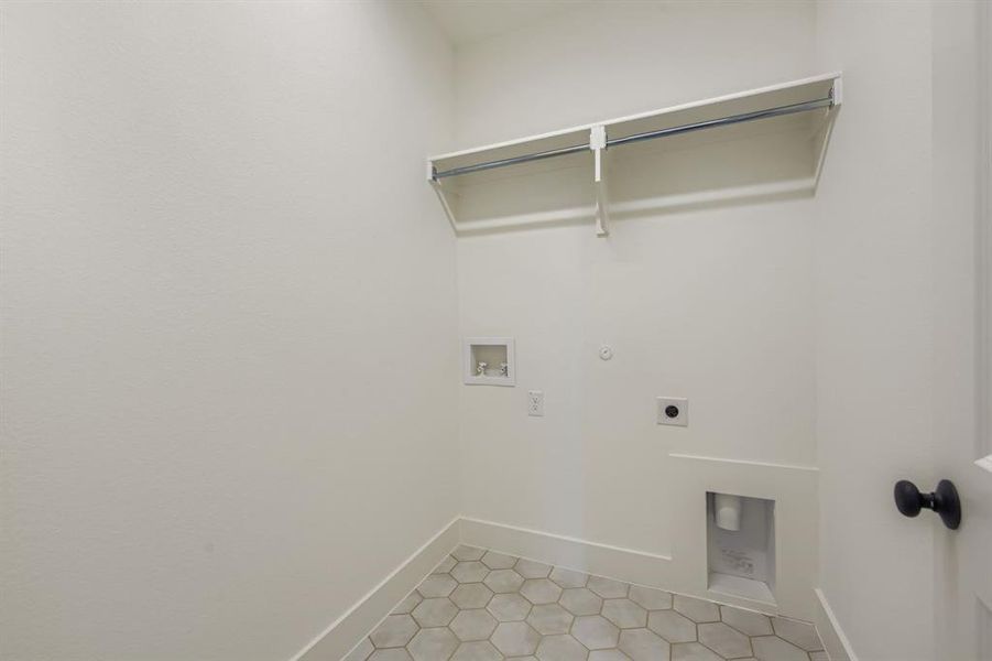 Laundry room featuring hookup for a gas dryer, electric dryer hookup, hookup for a washing machine, and light tile patterned floors Laundry room featuring hookup for a gas dryer, electric dryer hookup, hookup for a washing machine, and light tile patterned floors