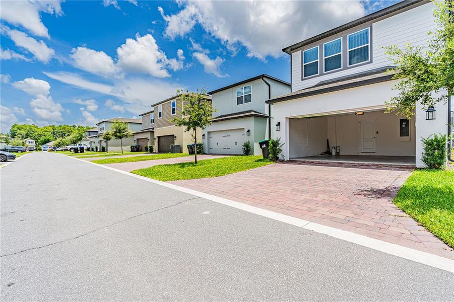 Front exterior of a new home in Encore at Ovation, Winter Garden, FL, highlighting curb appeal (Image 16).