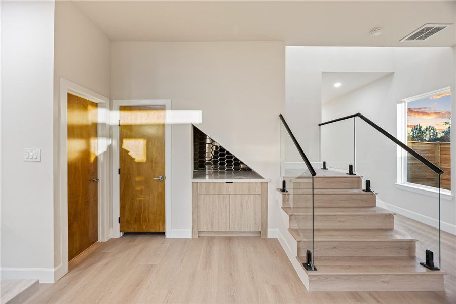 Stairway featuring wood finished floors and baseboards