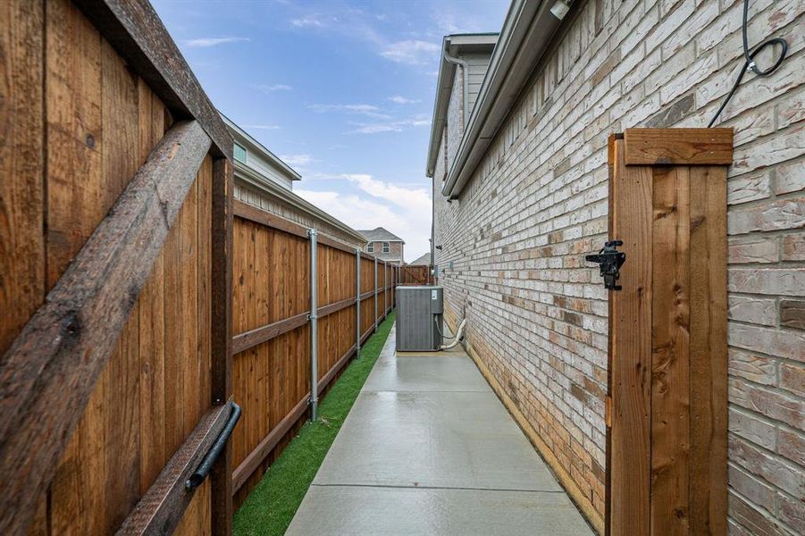 Concrete walkways on both sides of the home.