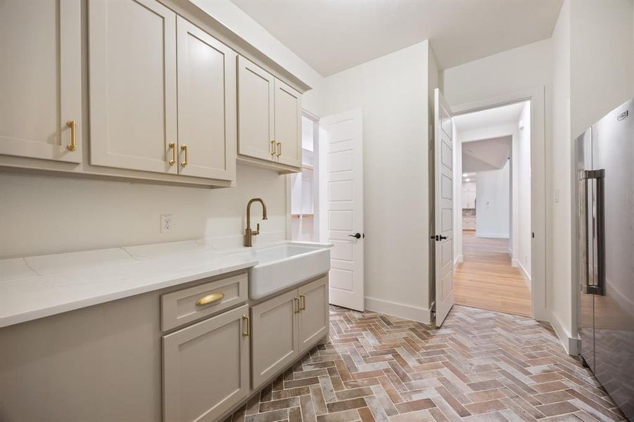 Washroom featuring brick patterned floors and a sink
