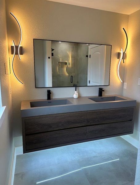 Bathroom with vanity and a shower with shower door