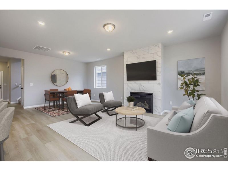 Great room features a gas fireplace surrounded by floor to ceiling tile