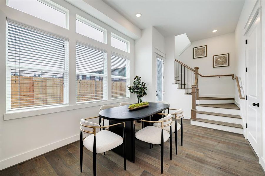 Sleek Dining Space: Bathed in natural light, this modern dining area offers a tranquil spot for intimate meals, framed by elegant windows and complemented by stylish, minimalist decor.