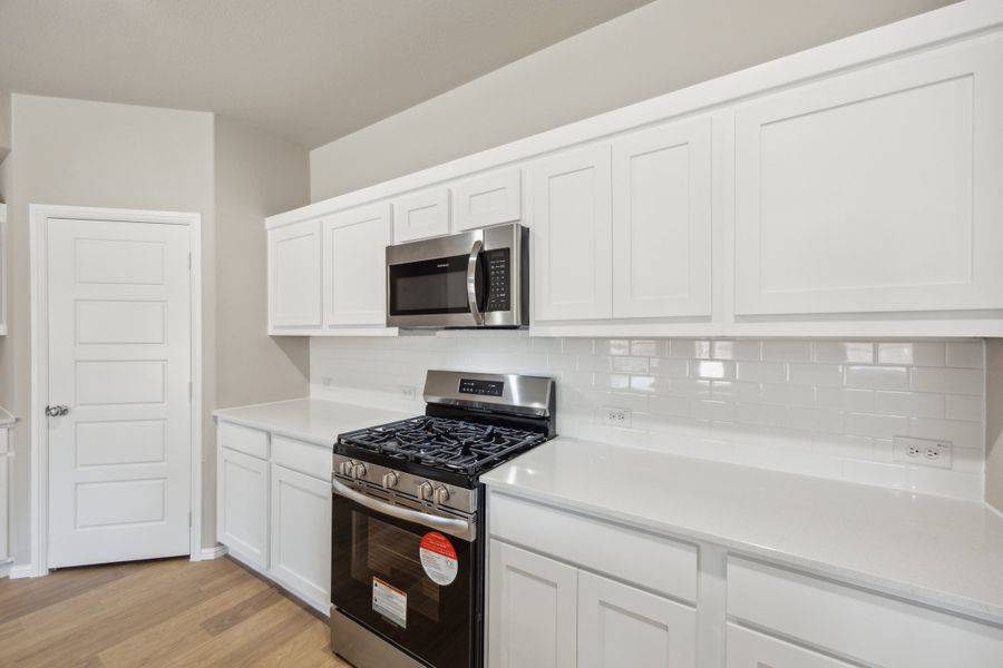 Kitchen in the Harper home plan by Trophy Signature Homes – REPRESENTATIVE PHOTO