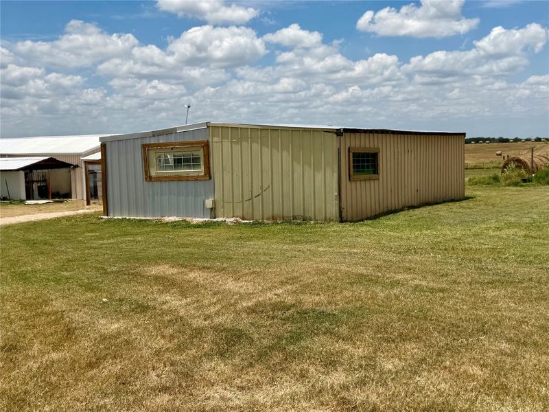 Used to be horse barn. A utilitarian outbuilding with metal siding offers versatile storage possibilities on a spacious lot.