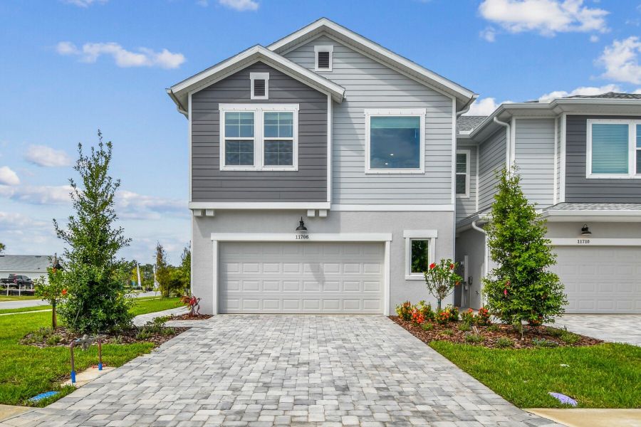 Front exterior of a new home in North River Ranch – Townhomes, Parrish, FL, highlighting curb appeal (Image 1).