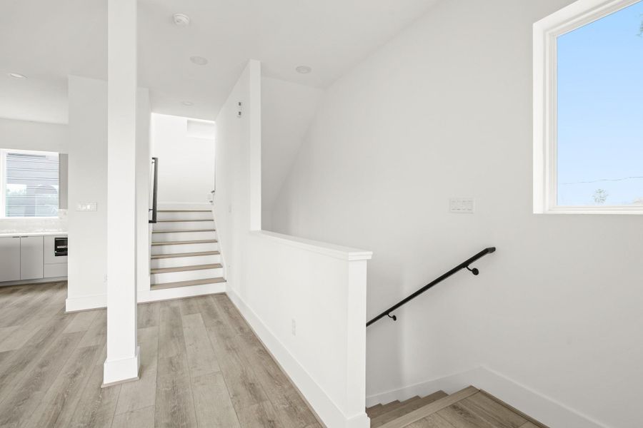 The staircase connecting the second and third levels features elegant wood treads and large windows which illuminate the stairwells. The staircase connecting the second and third levels features elegant wood treads and large windows which illuminate the stairwells.