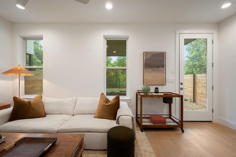 Sunlight fills this inviting dual living room/den/bedroom or flex space featuring gleaming hardwood floors and direct outdoor access. Sunlight fills this inviting dual living room/den/bedroom or flex space featuring gleaming hardwood floors and direct outdoor access.